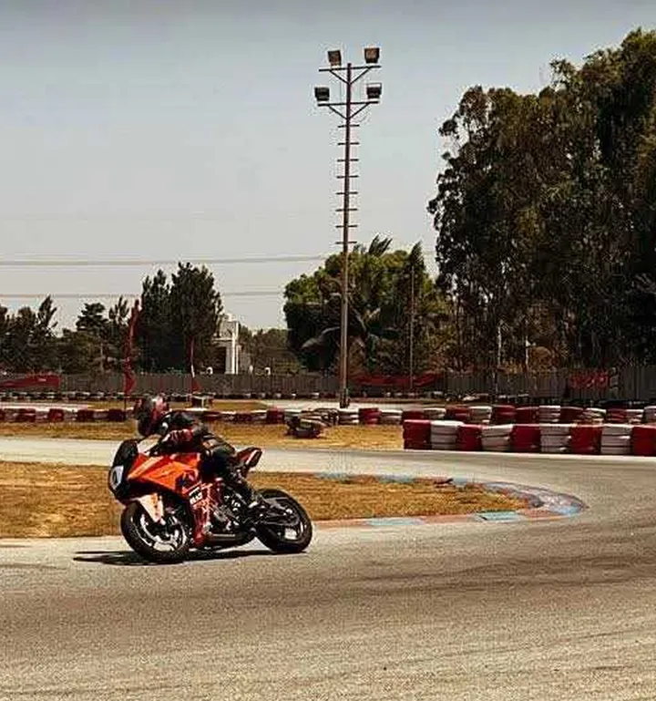 Uttham in riding gear on his motorcycle